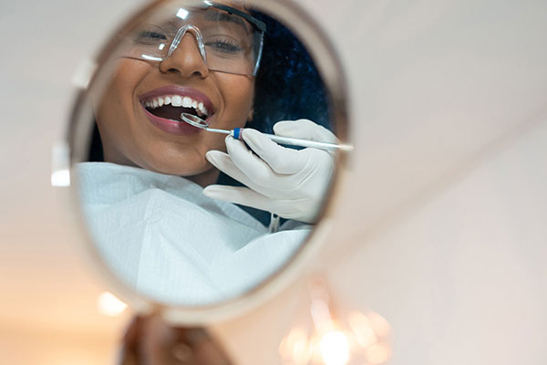 Patient looking at teeth in mirror
